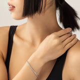 Model weaing BUBBLE TENNIS BRACELET which is classic Tennis Bracelet featuring a row of 3mm Moissanite round diamonds set in a silver band