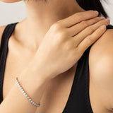 Model wearing the BUBBLE TENNIS BRACELET which is classic Tennis Bracelet featuring a row of 3mm Moissanite round diamonds set in a silver band