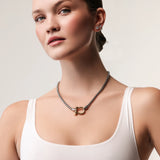 Model wearing the Herradura Signature Mix, a silver necklace featuring a box chain with a gold horseshoe clasp. ||| GOLD