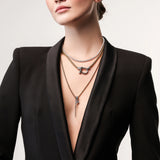 Model wearing the Herradura Signature Spiga Tennis Set, a luxurious layered necklace featuring mixed-metal chains, a tennis necklace, and signature charm details.