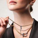 Model wearing The Herradura Signature Spiga Tennis Set, a luxurious layered necklace featuring mixed-metal chains, a tennis necklace, and signature charm details.