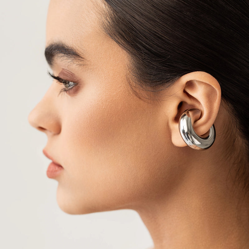 Model wearing a silver Chunky Bagel Ear Cuff, a silver ear cuff with a thick, rounded design.