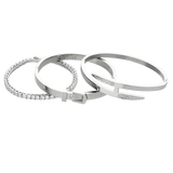 The **Core Stack**, a set of three sleek silver-tone bracelets, includes a sparkling stone bangle, a minimalist cuff, and a modern nail-inspired design, perfect for layering or wearing solo.