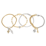 The Chain Reaction Bracelet Stack featuring gold and silver chains with diamond-encrusted charms, including a snowflake, teardrop, and triangle.