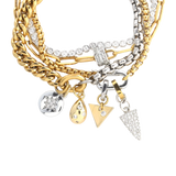 Chain Reaction Bracelet Stack featuring gold and silver chains with diamond-encrusted charms, including a snowflake, teardrop, and triangle.