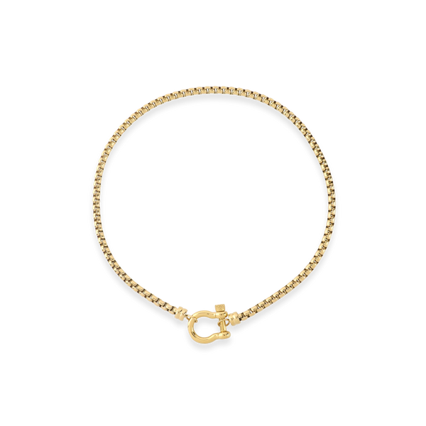 The Herradura Signature, a gold necklace featuring a box chain with a gold horseshoe clasp.