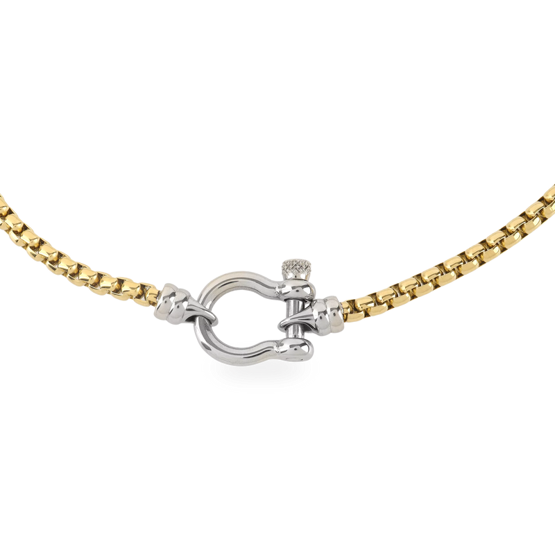 The Herradura Signature Mix, a gold necklace featuring a box chain with a silver horseshoe clasp.