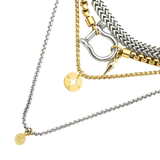 Layered necklace stack with four mixed-metal pieces featuring gold and silver chains, a Herradura pendant, and compass and coin charms. |||Silver