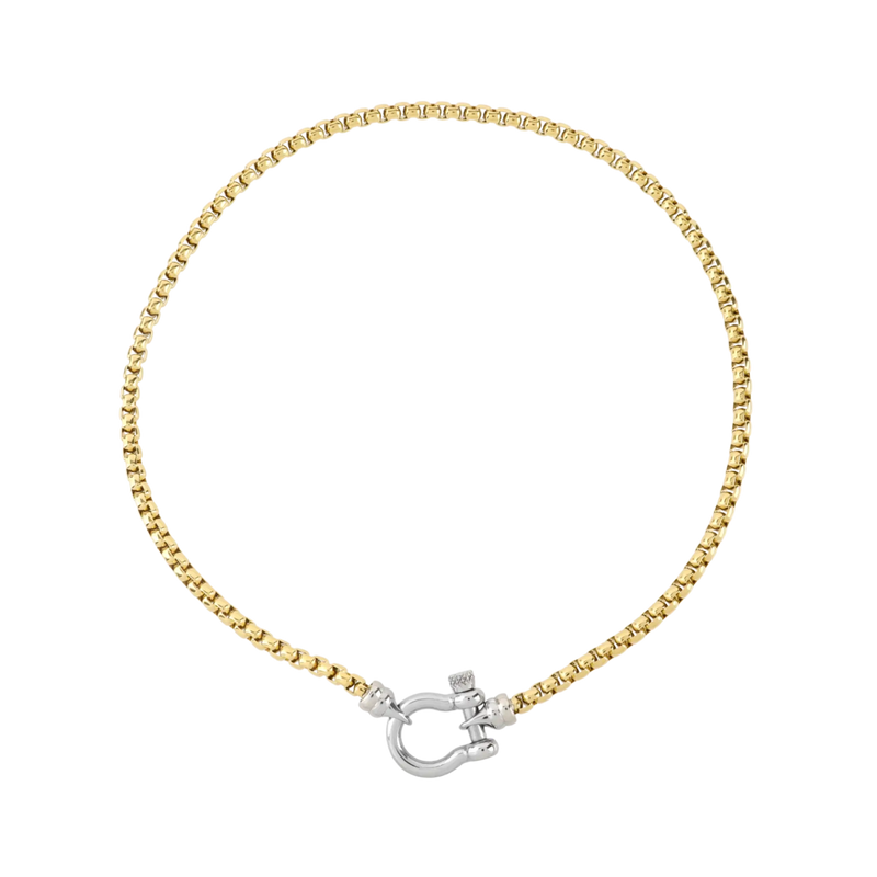 The Herradura Signature Mix, a gold necklace featuring a box chain with a silver horseshoe clasp. 