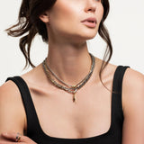 Model wearing the Just Click Nut Layered Necklace Set featuring four gold and silver chains with a mixed metal clasp and nut-inspired charm.