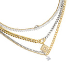 Mix Tennis Compass Layered Necklace Set featuring five gold and silver necklaces, including chain links, tennis strands, and a gold compass pendant.