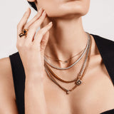 Gold and silver MIX TENNIS COMPASS NECKLACE SET layered on model, featuring a compass pendant, cubic zirconia, and mixed metal chains.
