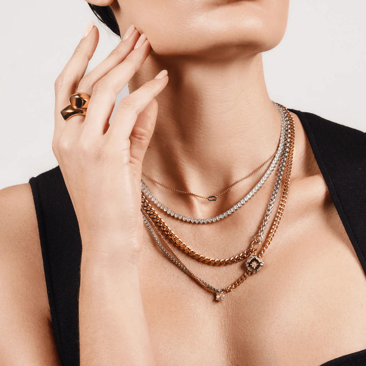 Gold and silver MIX TENNIS COMPASS NECKLACE SET layered on model, featuring a compass pendant, cubic zirconia, and mixed metal chains.