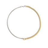 Close-up of OPPOSITES ATTRACT CHAIN NECKLACE, two-tone chain with silver box links on one side and gold Cuban links on the other, joined at the center with a gold oval connector. |||  MIX