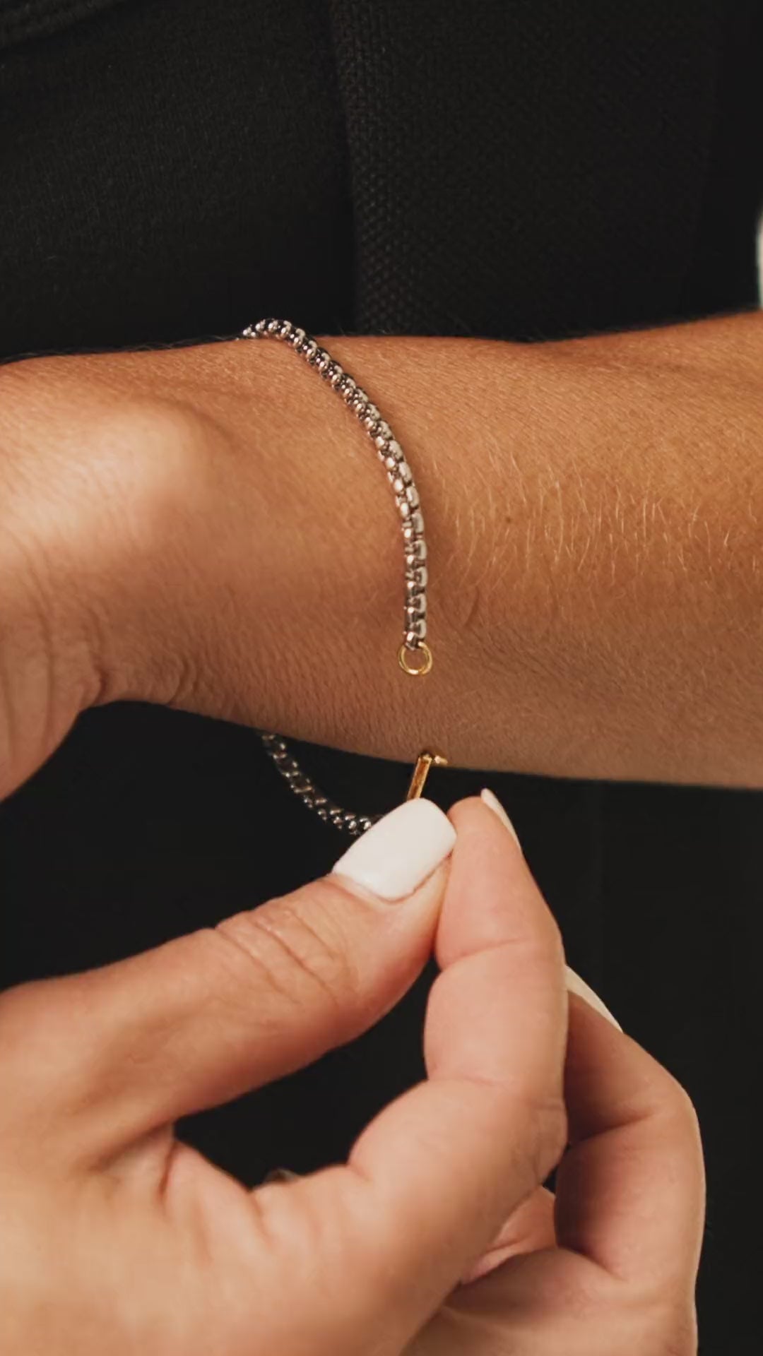 Video of a model putting on the Can Opener Box Chain Bracelet featuring a distinctive silver link design and a secure gold can opener clasp ||| GOLD