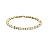 The ROUND CUT RIVIERE TENNIS BRACELET, which is a single gold bracelet featuring round-cut stones in a classic prong setting. Not worn by a model. ||| GOLD