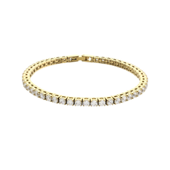 The ROUND CUT RIVIERE TENNIS BRACELET, which is a single gold bracelet featuring round-cut stones in a classic prong setting. Not worn by a model. ||| GOLD