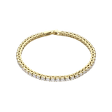 The ROUND CUT RIVIERE TENNIS BRACELET, which is a single gold bracelet with round-cut white stones in a bold prong setting. Not worn by a model. ||| GOLD