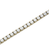 Close-up of a single ROUND CUT RIVIERE TENNIS BRACELET featuring round-cut white stones in a prong setting. Not worn by a model. ||| GOLD