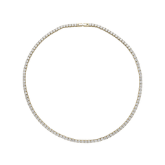 The ROUND CUT RIVIERE TENNIS NECKLACE, which is a single gold necklace featuring round-cut white stones in a classic prong setting. Not layered or worn by a model.