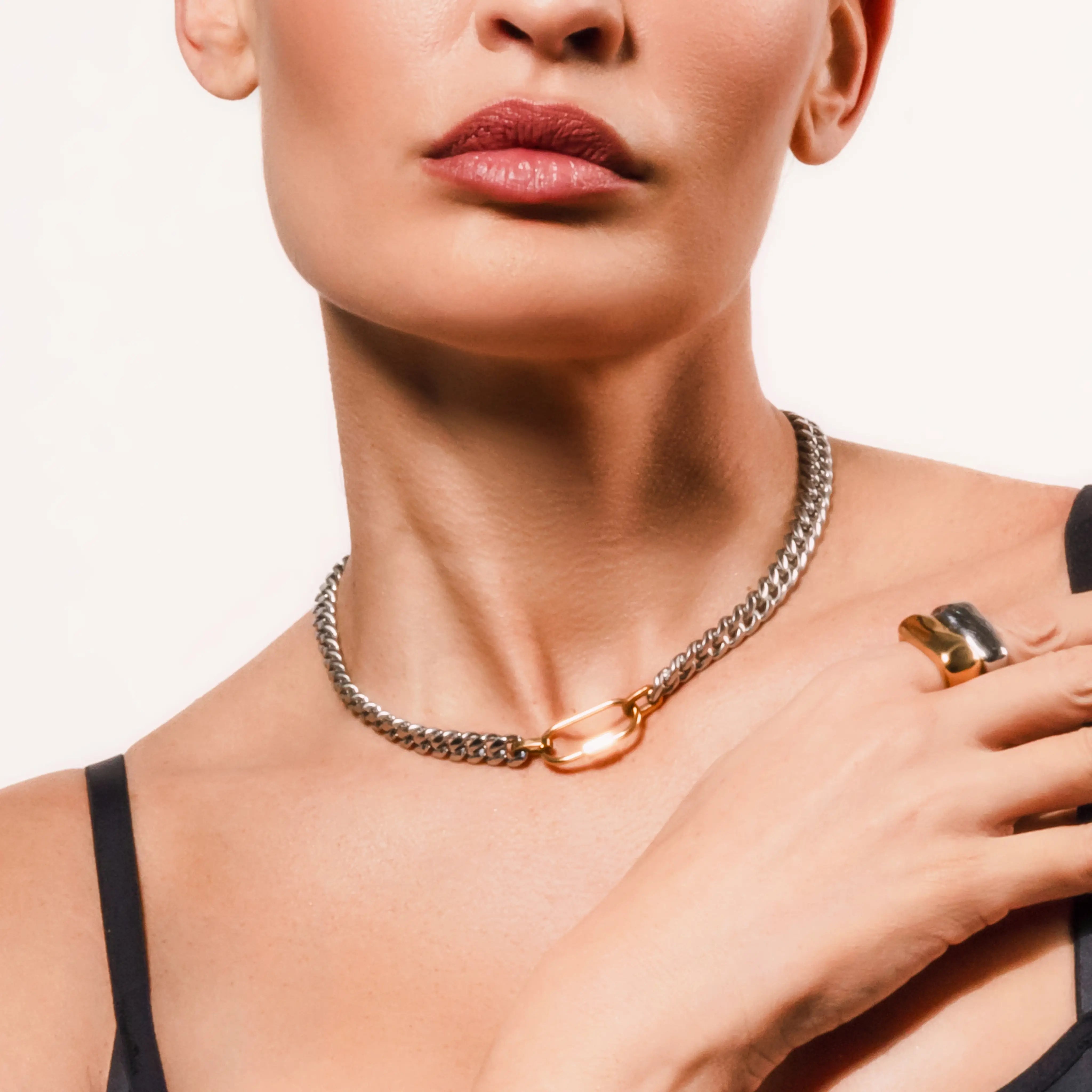 Model wearing the Sleek Carabiner Anne Mix Necklace featuring a bold mixed metal chain with a gold carabiner clasp centerpiece.