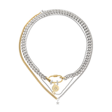 The Sleek Carabiner Cosmic Layered Necklace Set, which is a 3-piece mixed metal necklace set featuring layered silver and gold chains, a gold carabiner clasp, and celestial-themed charms including a star pendant and round charm with pavé accents.