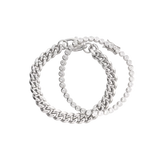 Close-up of The Bubble Curb Chain Bracelet Stack, a silver layered bracelet set featuring a chunky curb chain and a tennis bracelet with round-cut stones. ||| SILVER