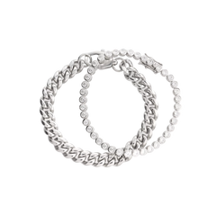 Close-up of The Bubble Curb Chain Bracelet Stack, a silver layered bracelet set featuring a chunky curb chain and a tennis bracelet with round-cut stones. ||| SILVER