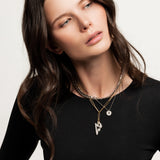 The Lightning layered necklace set, which is a three-piece layered necklace in mixed metals. The set includes a chunky silver chain, a gold chain with a bold lightning bolt pendant, and a delicate gold chain with a circular pendant, offering a striking contrast and a trendy layered look.