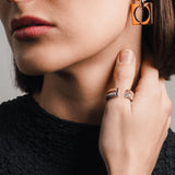 Gold and silver **Square Mix Hoops Earrings** paired with two stacked mixed metal rings and a crystal-accented ring. ||| GOLD