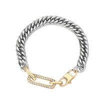 The Ischia Bracelet, a bold two-tone bracelet featuring a thick silver chain and a gold crystal-encrusted paperclip link accent. This stylish piece combines silver and gold elements, perfect for adding a touch of modern elegance and contrast to any look.