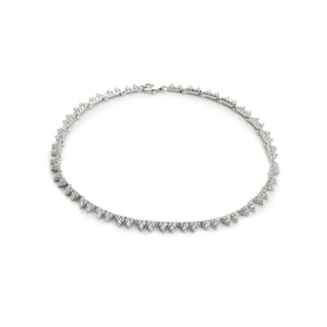 The Zippy Zirconia Necklace, a silver necklace with a repeating pattern of  sparkling triangle-shaped cubic zirconia stones.