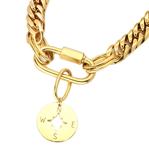Elizabeth Necklace which is a gold chunky chain with oval lock and hanging compass pendant.
