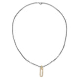 The Procida Necklace, which is a single-piece silver chain necklace, features a sleek chain accented with a gold rectangular pendant adorned with shimmering stones, offering a sophisticated blend of mixed metals for a modern and elegant statement.