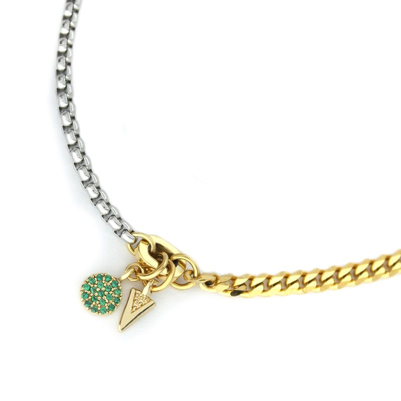 The RISTRETTO BLENDED BRACELET which is a 7" half stainless steel chain and half stainless steel 18k gold plated chain with an 18k gold plated triangular and green zirconia pendant.