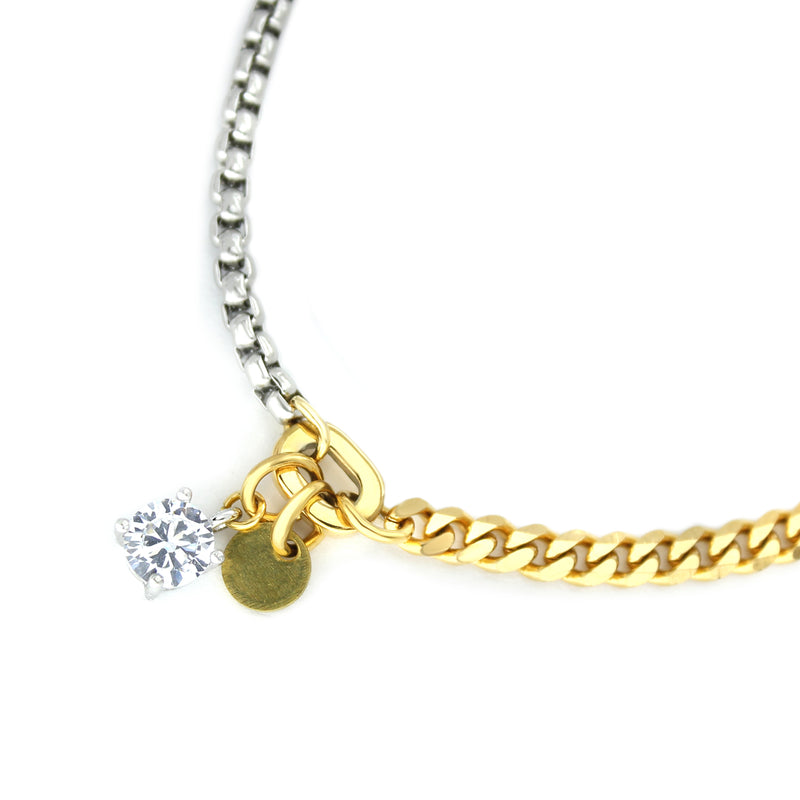 The LUNGO BLENDED BRACELET is a 7" bracelet which is half stainless steel and half 18k gold plated chain with Zirconia pendant solitaire and brass raw coin.