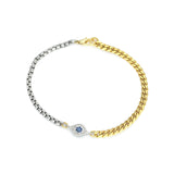 The Crema Blended Bracelet, which is a single-piece bracelet, combines both gold and silver chain links, featuring a central eye-shaped charm adorned with a blue stone and sparkling accents, creating a striking and elegant contrast.