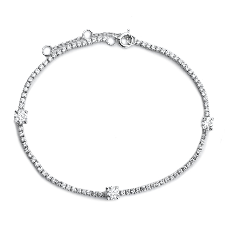 The THIN TENNIS BRACELET which is made of 925 sterling silver and Cubic zirconia. It is filled with small zirconias and 3 Four Prongs zirconias that are 5.5mm each.
