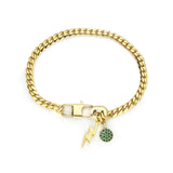 The ORZO BLENDED BRACELET, which is a single gold bracelet with a curb chain design, features playful charms, including a green gem-encrusted circle and a sleek lightning bolt. This bold and versatile accessory adds a pop of color and character, perfect for stacking or wearing alone for a statement look.