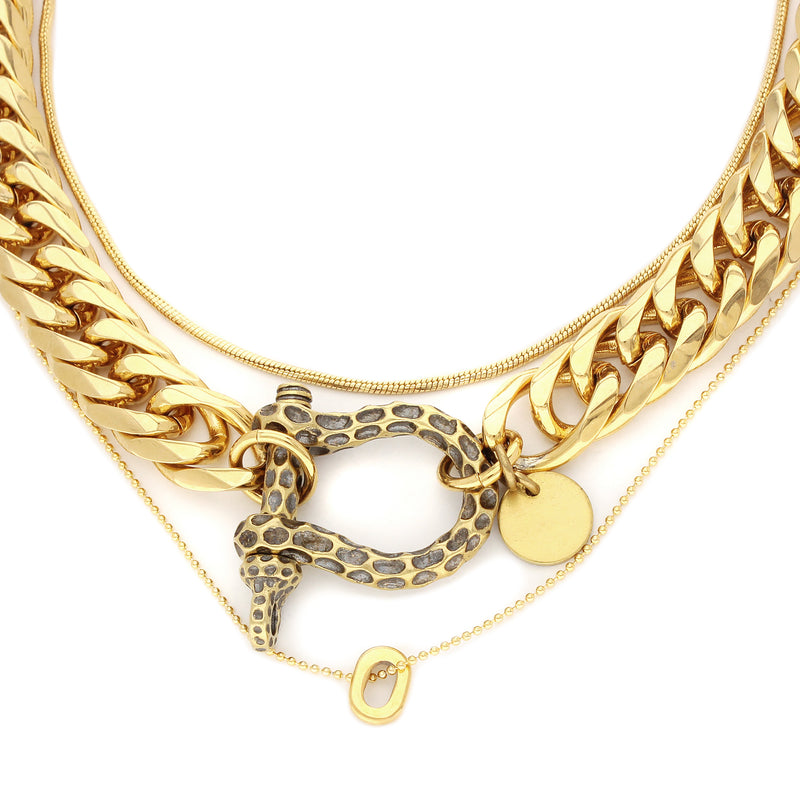 Le Giraffe Herradura necklace set which includes 3 separate chains, chunky gold chain with herradura clasp designed like giraffe skin with a small gold disc charm, short gold thin chain and long thin gold chain with circle charm.