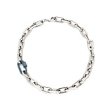 The SAN MARINO PUERTO NECKLACE, which is a single statement necklace crafted from silver-tone chain links with a striking blue pavé-accented clasp for added elegance. This bold and modern piece is perfect for elevating any outfit.