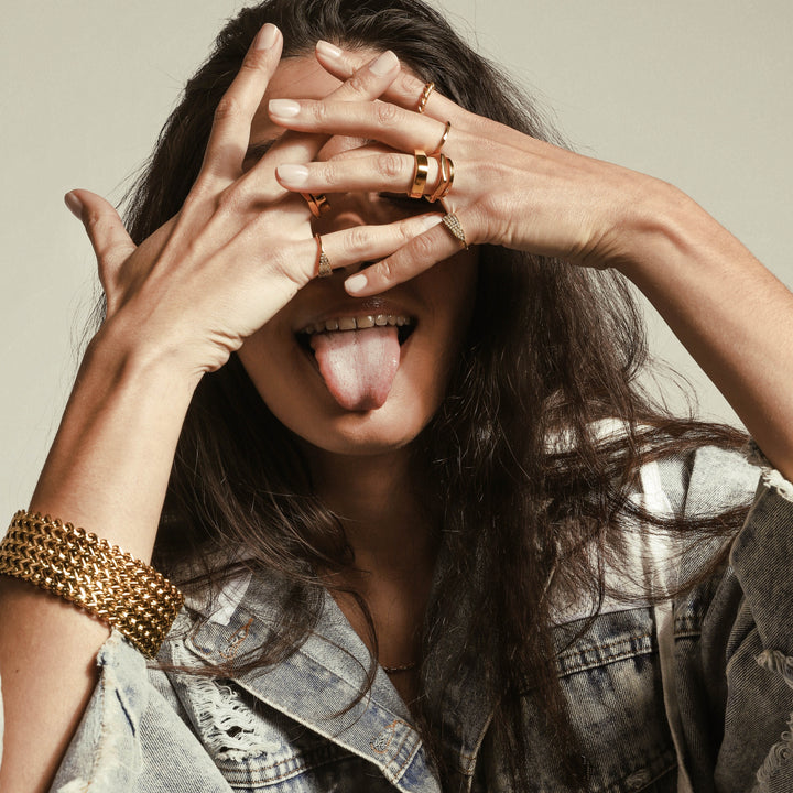 Model wearing the THIN STACK RING which includes 2 18k Gold plated rings. One is the Rhombus ring with the shape of pentagon and the other is THE THIN RING. She is also wearing the Dynamic Bracelet.