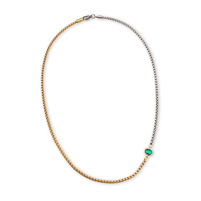 Emerald Point Necklace which is a half gold and half silver thin chain separated with a small green emerald stone.