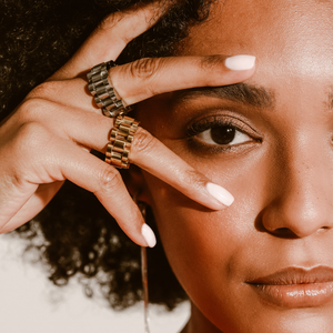 Model wearing two MOVE RINGS which looks like a bicycle chain. It's 10mm wide and made of 18k gold plated and non tarnish stainless steel.