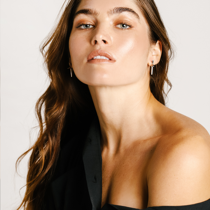 Model wearing a pair of Stars Earrings which comes in stainless steel star shaped earring and 3cm in size.