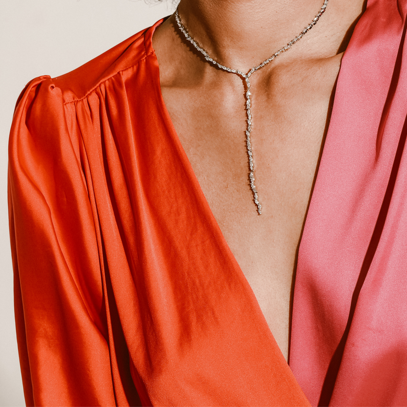 Model is wearing The TEEPING POINT NECKLACE which is a drop necklace made of 925 sterling silver and an Adjustable Necklace Paved Zircon. The drop length is 100mm.