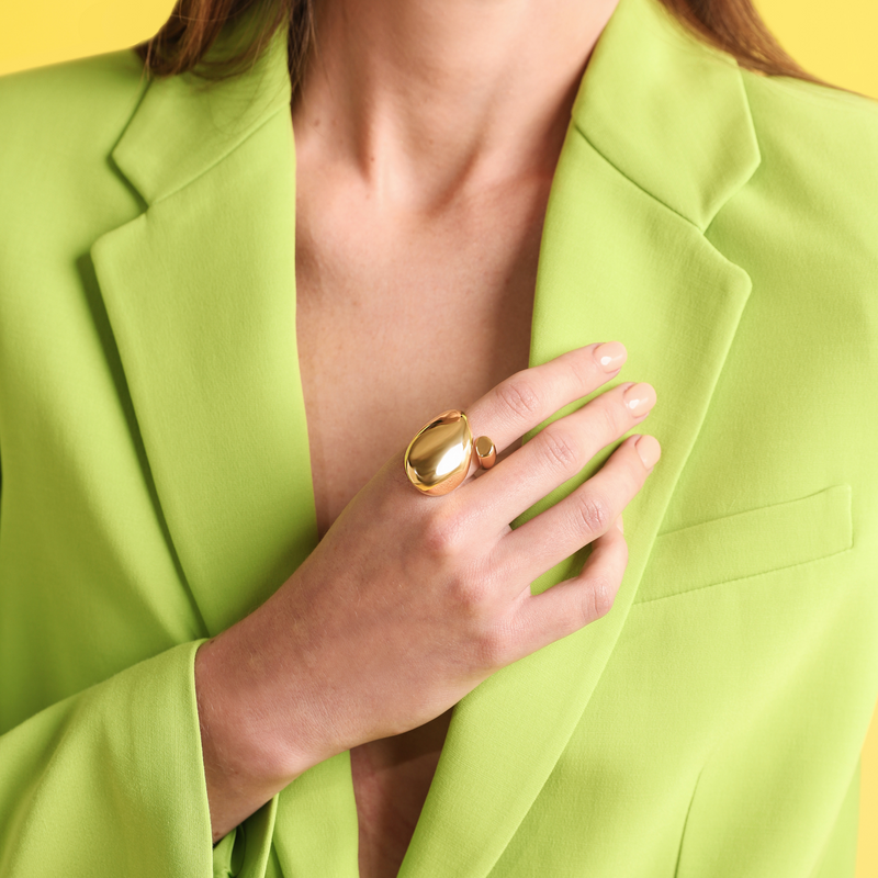 Model wearing the Ardent Ring which is made of 18k gold plated brass. It is a huge round shaped ring that can be adjusted or resized.