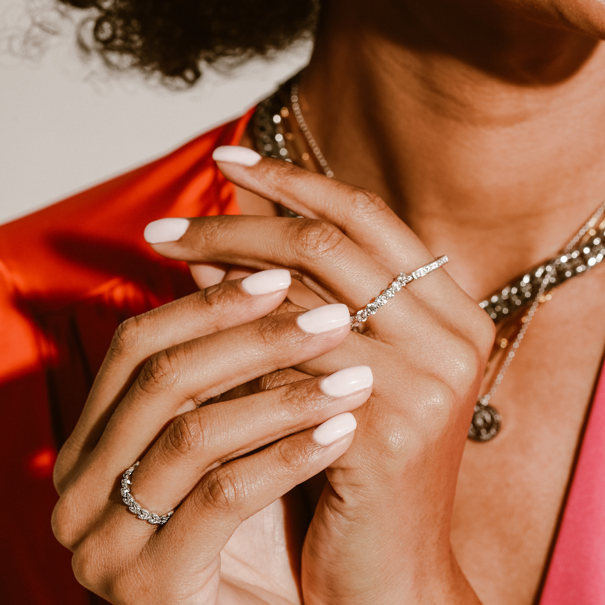 Model wearing the Eternity ring which is 3mm in width made of 925 sterling silver covered with Cubic zirconia. and also two other silver with zirconia rings.