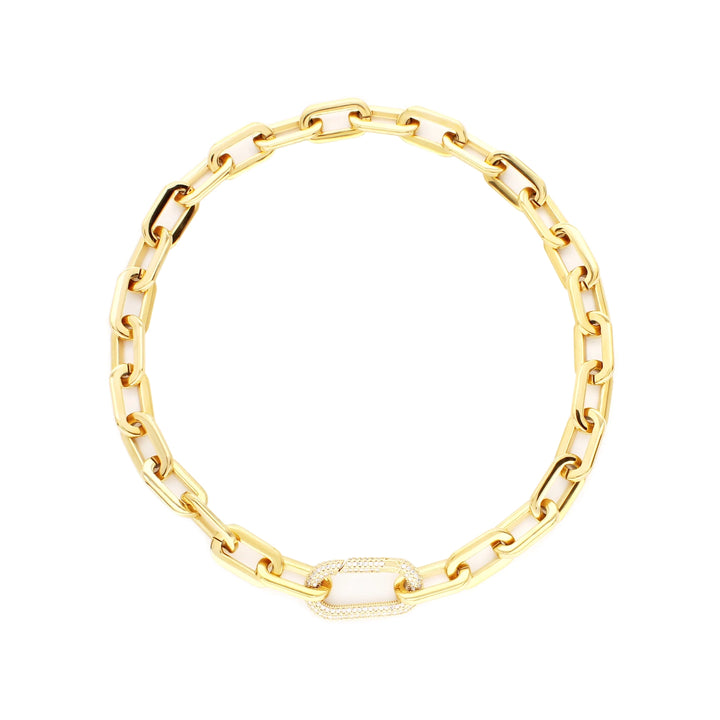 The PUERTO FINO NECKLACE, which is a single gold chain necklace, features a bold link design with a sparkling pavé-embellished clasp centerpiece. This elegant gold piece is perfect for adding a touch of sophistication to any outfit, whether casual or formal.