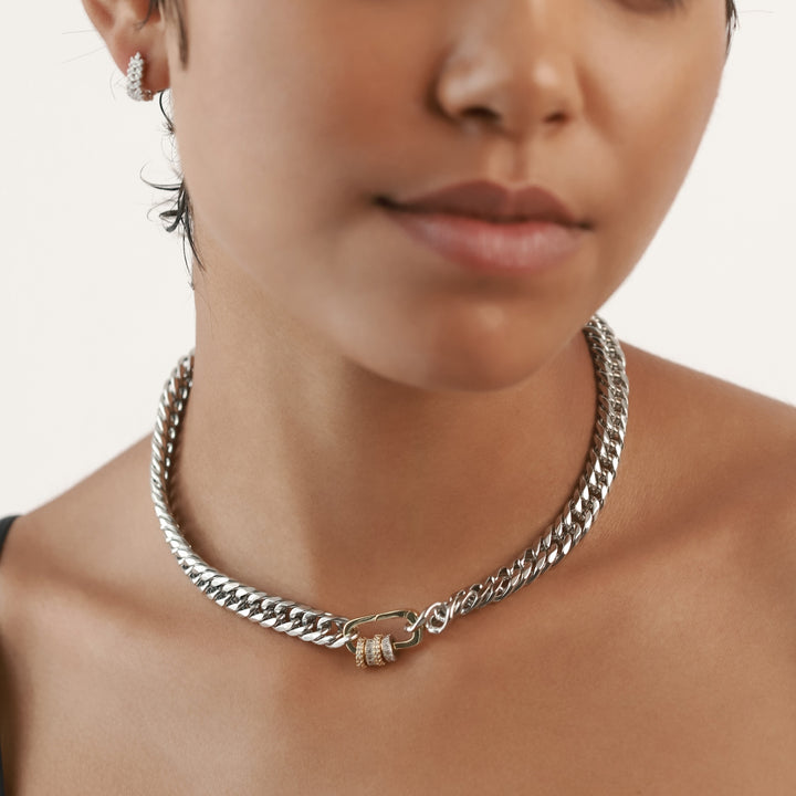 The JUST CLICK HOOPS CHAIN, a single silver chain necklace with a contrasting gold click clasp adorned with sparkling donut-shaped accents, offering a bold mixed-metal statement ||| MIX